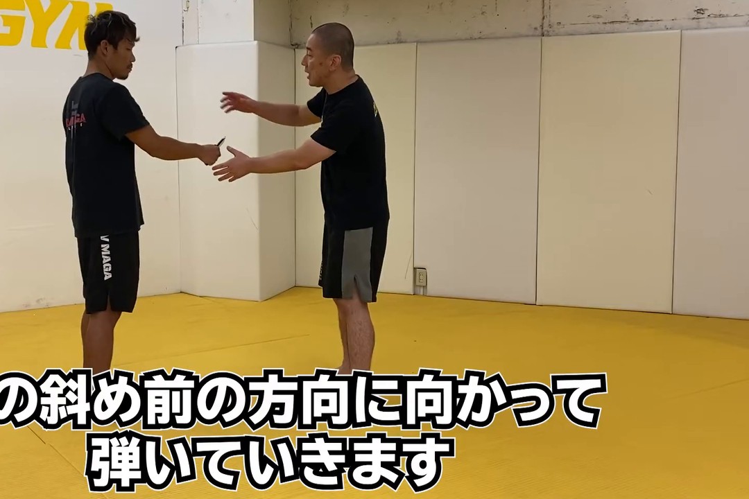 刃物を持った手の甲を、斜め前の方向に手で弾く瞬間